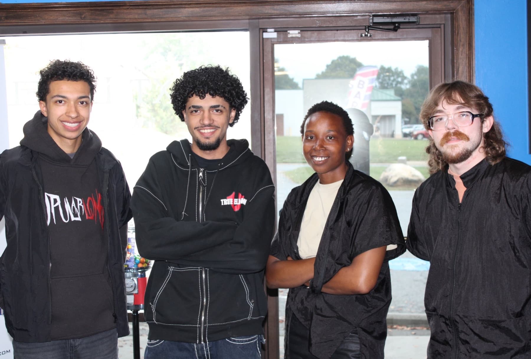 Four students in the Paramount Barber Academy doorway in Gastonia, NC.