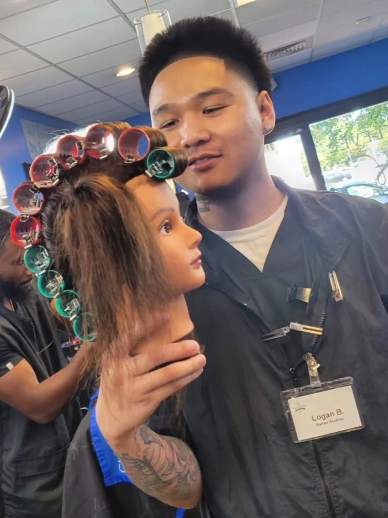 A student at a barber chair during clinic hours.